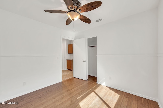 8009 W Salter Dr, Peoria, AZ 85382 - unfurnished bedroom with light wood-style flooring, a closet, baseboards, and a ceiling fan