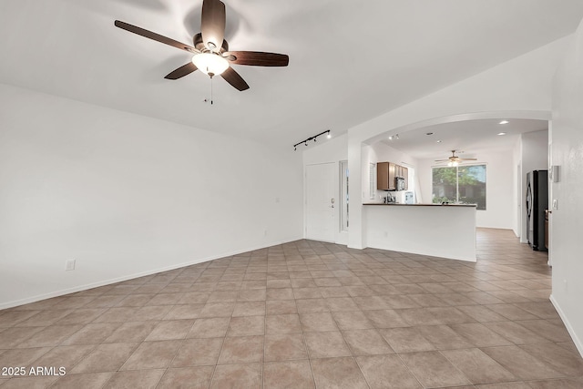 8009 W Salter Dr, Peoria, AZ 85382 - unfurnished living room with a ceiling fan, arched walkways, and track lighting