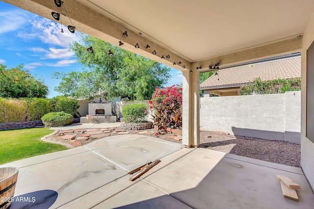 8009 W Salter Dr, Peoria, AZ 85382 - fenced backyard featuring exterior fireplace and a patio area