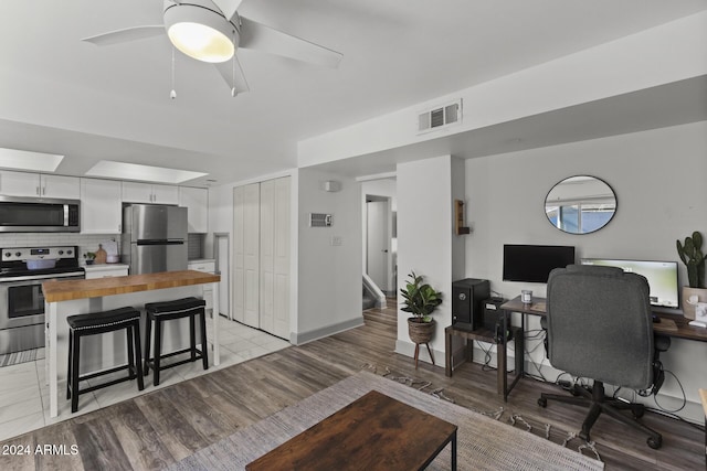 office space featuring light hardwood / wood-style floors and ceiling fan