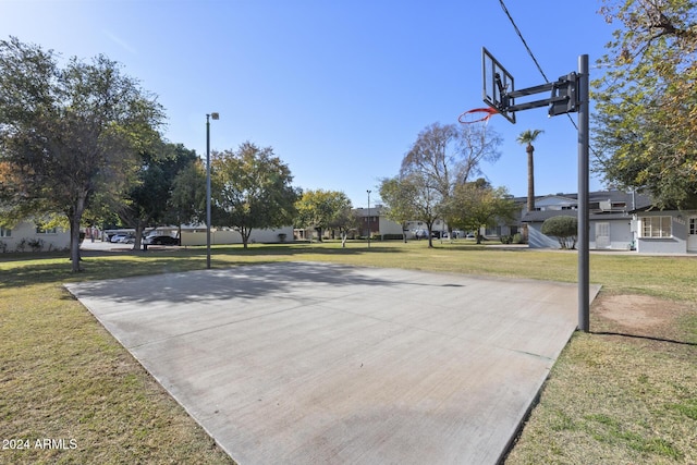 view of basketball court featuring a yard