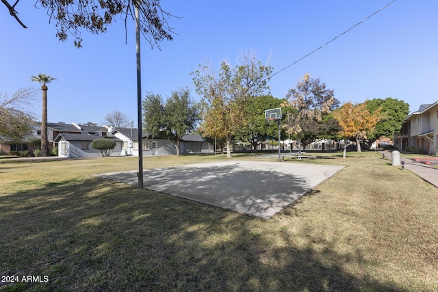 view of basketball court with a yard