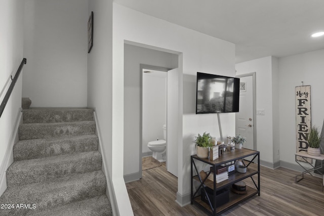 staircase featuring hardwood / wood-style flooring