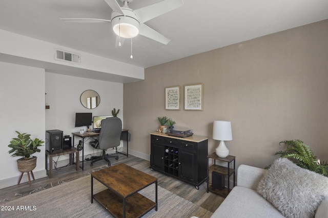 office area with ceiling fan and dark wood-type flooring