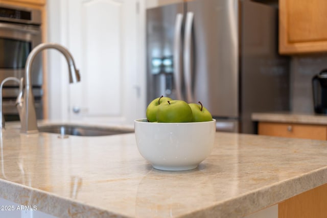 interior details with light countertops, a sink, and stainless steel appliances