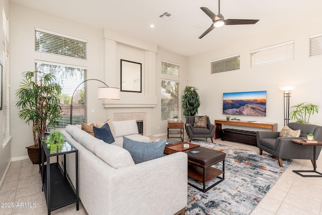 living area featuring visible vents, a wealth of natural light, and light tile patterned floors