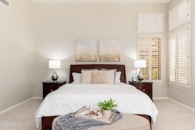 carpeted bedroom with baseboards and visible vents