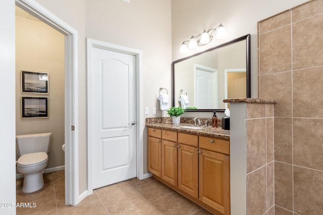full bath featuring tile patterned flooring, toilet, and vanity