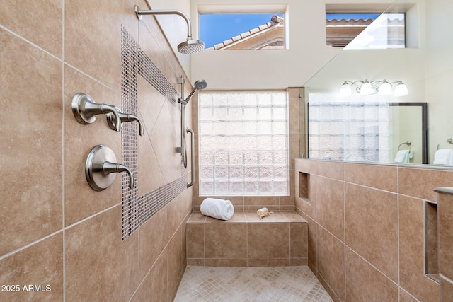 full bathroom featuring plenty of natural light and tiled shower