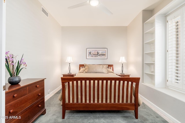 carpeted bedroom with visible vents, baseboards, and ceiling fan