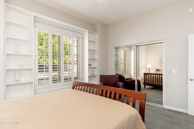 bedroom with baseboards, carpet flooring, and a closet