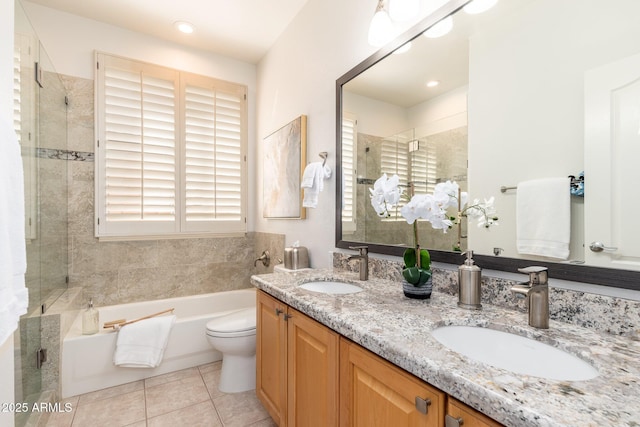 bathroom with tile patterned floors, a shower stall, a sink, and a garden tub