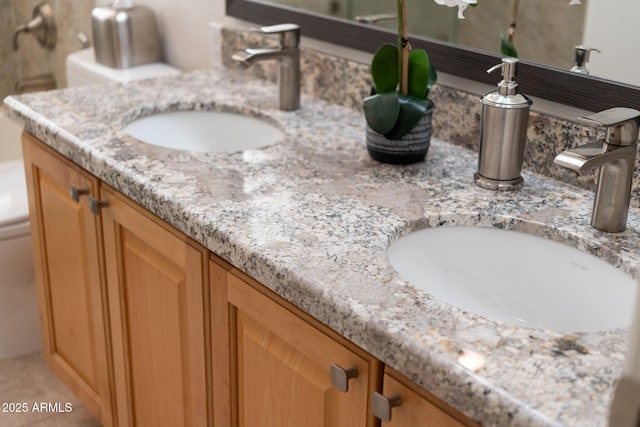 bathroom featuring a sink and double vanity