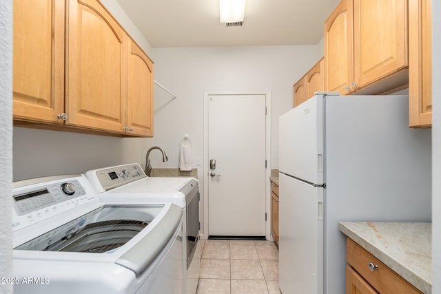 laundry area featuring laundry area, light tile patterned floors, and washer and dryer