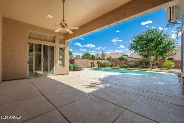 view of swimming pool featuring a fenced backyard, a fenced in pool, ceiling fan, and a patio area