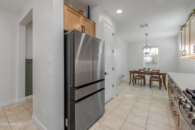 kitchen with a chandelier, light tile patterned floors, light countertops, visible vents, and appliances with stainless steel finishes