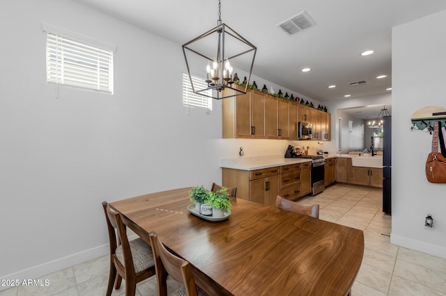 dining area featuring baseboards, a notable chandelier, and visible vents