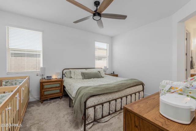 bedroom featuring light colored carpet and ceiling fan