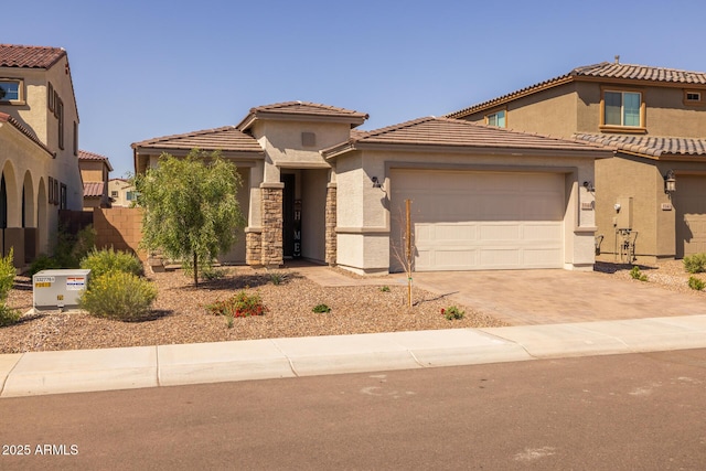 view of front facade with a garage, driveway, stucco siding, and a tile roof