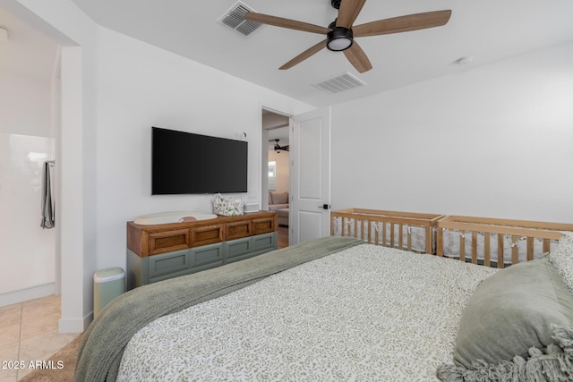 bedroom featuring visible vents, baseboards, ceiling fan, and tile patterned flooring