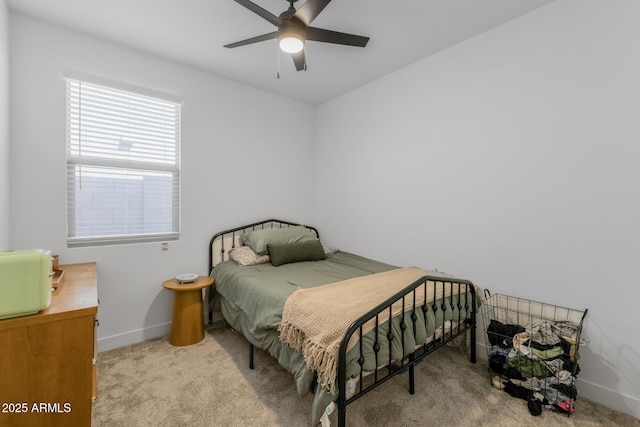 carpeted bedroom featuring baseboards and ceiling fan