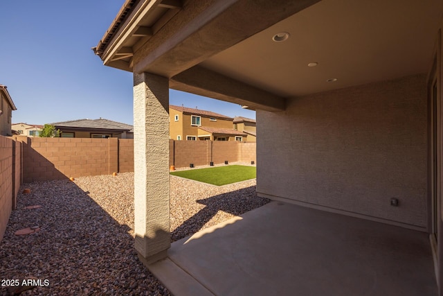 view of patio / terrace featuring a fenced backyard and a residential view