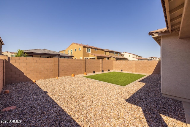 view of yard with a residential view and a fenced backyard