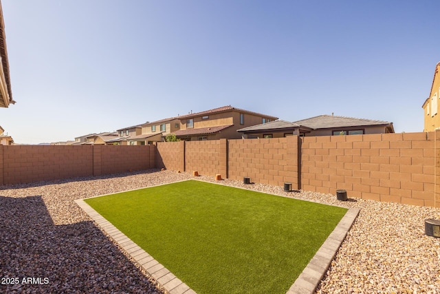 view of yard with a fenced backyard