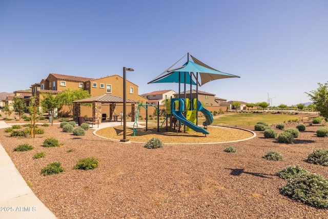 community play area featuring a gazebo and a residential view