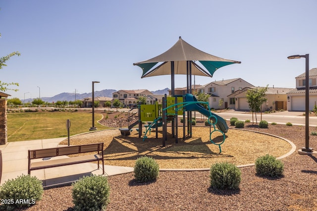 community playground featuring a residential view, a mountain view, and a lawn