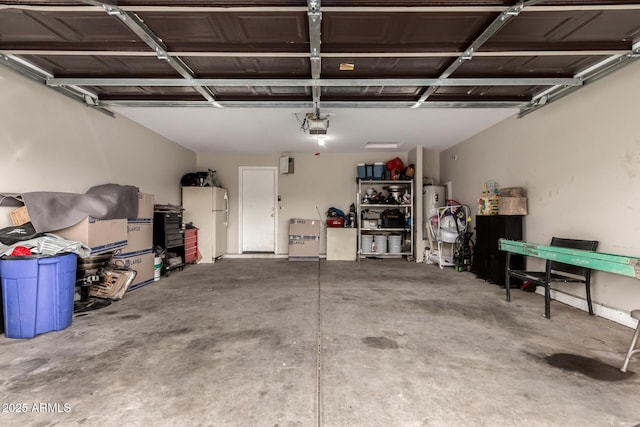 2509 E Meadow Land Dr, San Tan Valley, AZ 85140 - garage featuring freestanding refrigerator, a garage door opener, and electric water heater