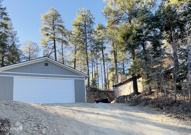 view of property exterior featuring an outdoor structure and a garage