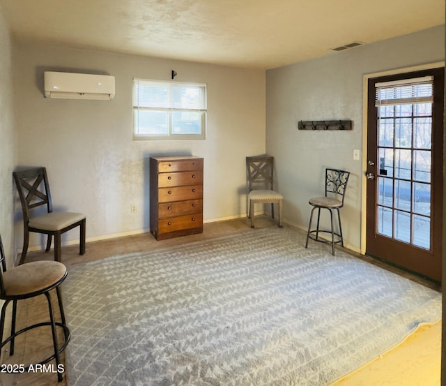 sitting room featuring a wealth of natural light, carpet, and a wall mounted air conditioner