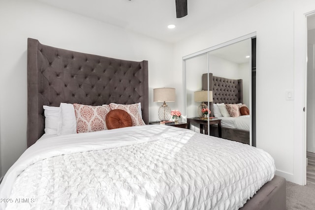 carpeted bedroom with a closet and ceiling fan