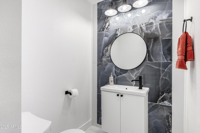 bathroom featuring sink, toilet, and tile walls