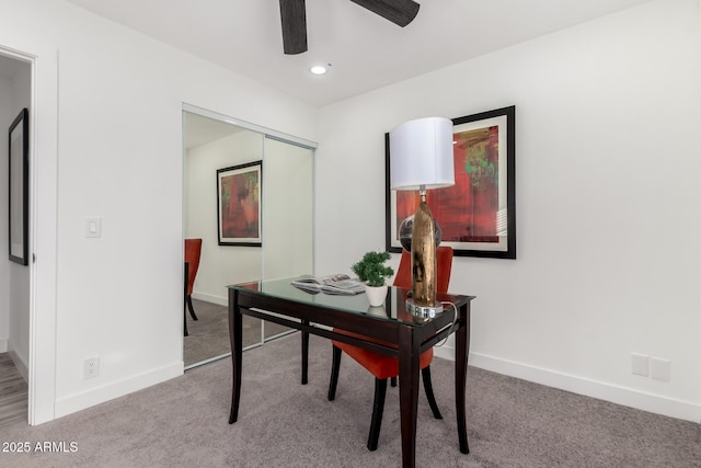 carpeted office space featuring ceiling fan