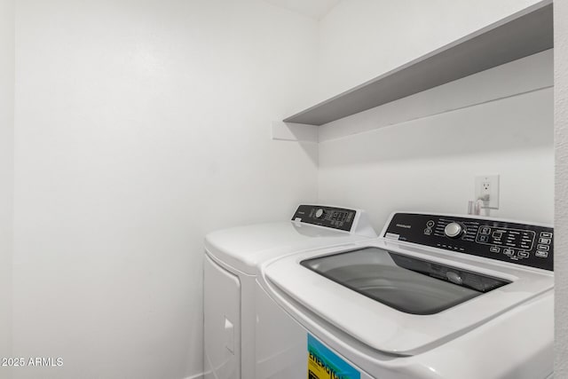 washroom with washing machine and clothes dryer