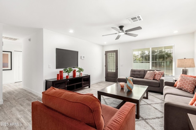 living room featuring light hardwood / wood-style floors and ceiling fan