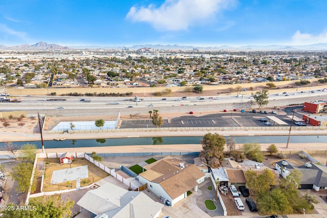 drone / aerial view featuring a water and mountain view