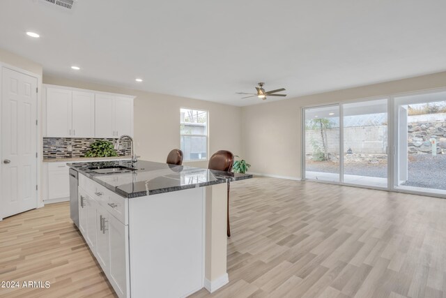 kitchen with white cabinetry, plenty of natural light, and sink