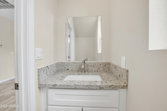 bathroom with vanity and hardwood / wood-style floors