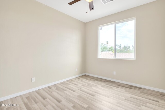 empty room with ceiling fan and light hardwood / wood-style flooring