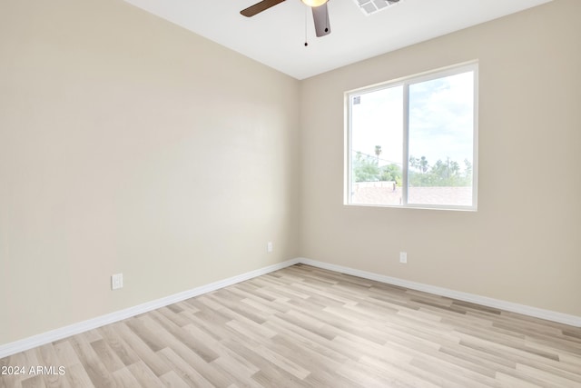 unfurnished room with light wood finished floors, visible vents, ceiling fan, and baseboards