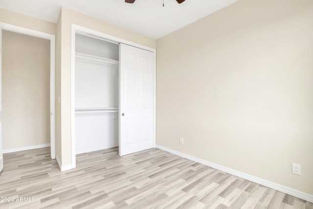 unfurnished bedroom with ceiling fan, a closet, and light hardwood / wood-style floors