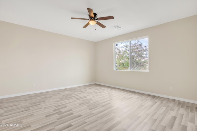 spare room featuring light hardwood / wood-style flooring and ceiling fan