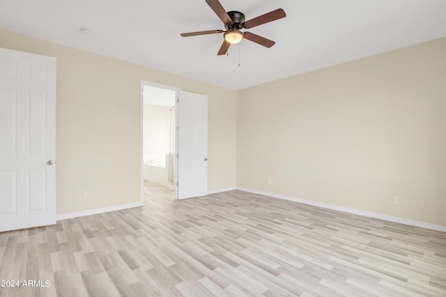 unfurnished room with ceiling fan, light wood-type flooring, and baseboards