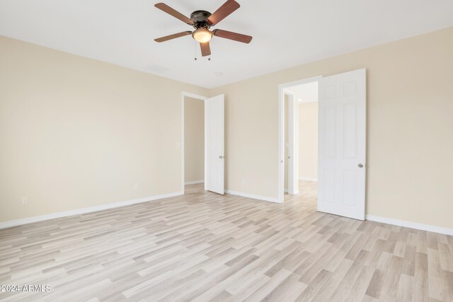 spare room featuring light hardwood / wood-style flooring and ceiling fan