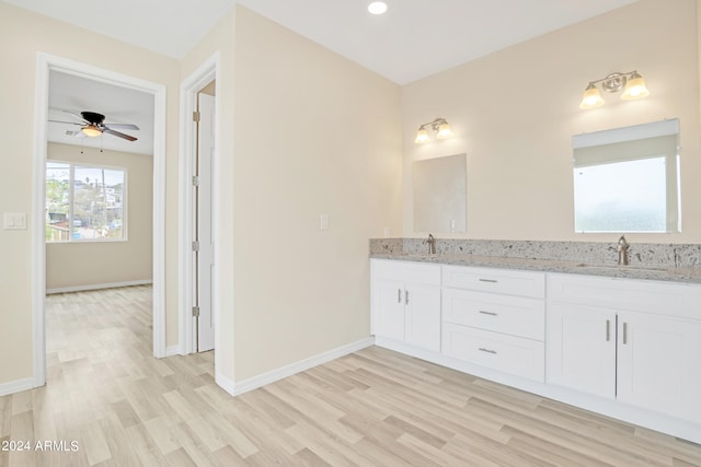 bathroom featuring ceiling fan, wood-type flooring, and vanity