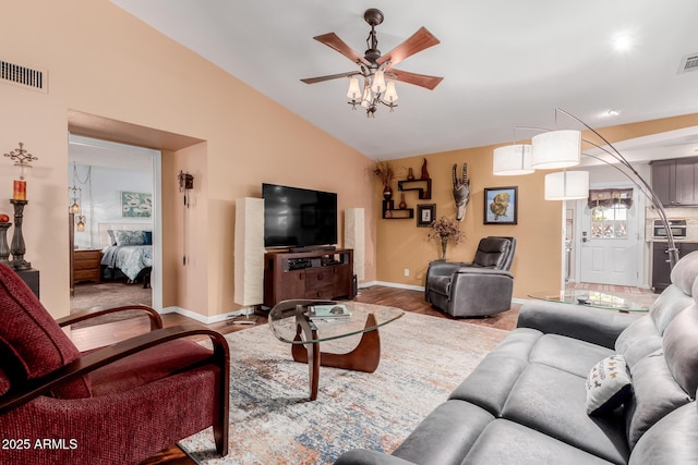 living room featuring hardwood / wood-style flooring, ceiling fan, and lofted ceiling