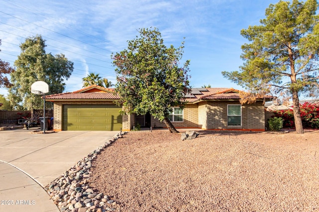 view of front of house featuring a garage and solar panels